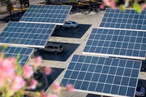 Close up solar panels placed on a city public parking lot.